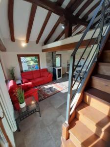 a living room with a red couch and stairs at Tranquillità e Relax in Villeneuve
