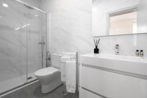 a bathroom with a toilet and a sink and a shower at Via Augusta 129 in Lisbon +64 photos