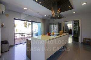 a kitchen with a large island in a house at Aqua Villa by AcasaDasCasas in Ericeira