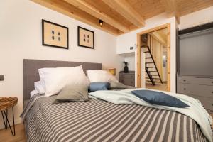 a bedroom with a bed with a striped blanket at Little beach house in Baška