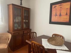 a dining room with a table and a cabinet at Casa do Ferreiro in Tolosa