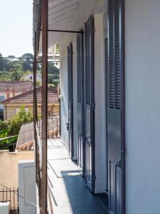 a row of shuttered windows on a building at Logement Le Serein in Toulon