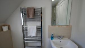 a bathroom with a sink and a mirror at Edinample Lodge in Lochearnhead +20 photos