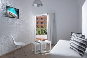 ヘルソニソスにあるFedra Boutique Apartmentsの白レンガの壁の白いリビングルーム