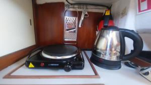a toaster and a tea kettle sitting on a counter at FRACTAL - Vintage Sailboat in Belém in Lisbon +19 photos