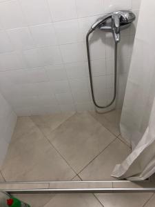 a bathroom with a shower with a tile floor at White House in Pleven +22 photos