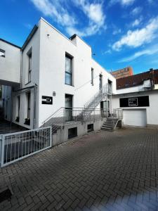 a white building with stairs on the side of it at mala me Hotel in Hannover
