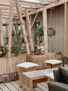 a patio with tables and chairs and potted plants at Guesthouse Klitmøller in Klitmøller +17 photos