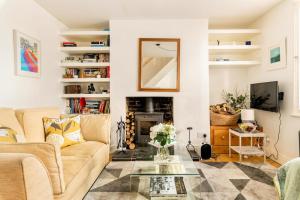 a living room with a couch and a fireplace at Beautiful little Townhouse situated in Brighton's Regency Conservation Area in Brighton & Hove
