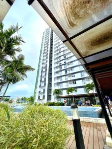 a large apartment building with a pool and palm trees at City View Studio Unit at Centrio Tower beside Ayala Mall in Cagayan de Oro