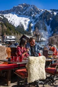 a man and a woman sitting at a table with wine glasses at Le Coucou Hotel Restaurant & Lounge-Bar in Montreux