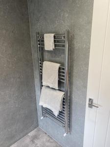 a towel rack with towels on it in a bathroom at Clavens House in Glasgow