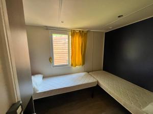 a small room with a bed and a window at VULCANO in Sottomarina