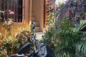 a motorcycle parked in front of a building with plants at A Parallag apartment in Manila