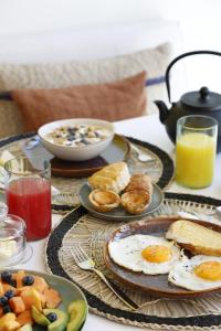 a table topped with plates of eggs and breakfast foods at Pátio do Tijolo in Lisbon
