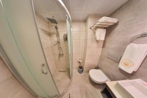 a bathroom with a shower and a toilet at BUKAVİYYE HOTEL in Ankara