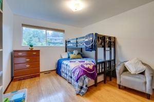 a bedroom with a bunk bed and a chair at Spacious Lake Forest Park Home with Deck! in Lake Forest Park
