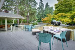 a patio with a couch and chairs and a table at Spacious Lake Forest Park Home with Deck! in Lake Forest Park