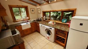a kitchen with a washer and dryer in it at View Cottage in Lochearnhead