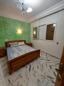 a bedroom with a bed and a marble floor at Appartement S2 Kantaoui vue mer in Port El Kantaoui