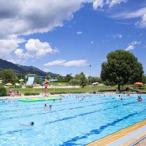 a large swimming pool with people in the water at Maryhouse in Borso del Grappa