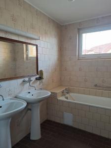 a bathroom with two sinks and a tub and a mirror at Zdeňka in Vracov