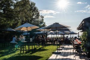 a group of people sitting at tables with umbrellas at Le Coucou Hotel Restaurant & Lounge-Bar in Montreux