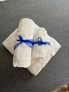 a white towel with a blue ribbon on it at Maison Sferisterio in Macerata