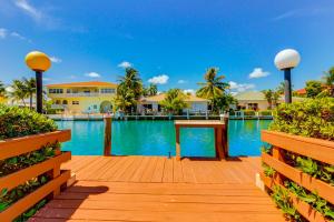 a boardwalk leading to a pool at a resort at Canal-side Charisma in Key Colony Beach