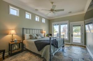 a bedroom with a bed and a ceiling fan at Lake Livingston Paradise Outdoor Pool with Slide! in Coldspring +28 photos