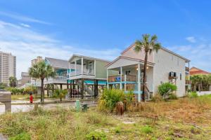 a house on the beach with palm trees at Sunbeam in Navarre