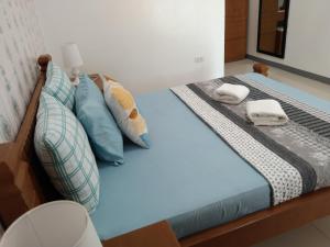 a bed with towels and pillows on it at ELEN INN - Malapascua Island Air-conditioned Room1 in Malapascua Island