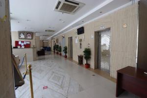 a hallway of a building with potted plants at Ayan ALMUEABADH -1700m to ALharam in Mecca