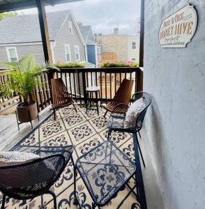 a patio with three chairs and a table on a balcony at Beautiful Chicago 2BD 1BA in Chicago