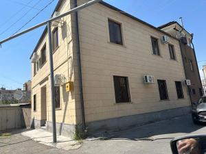 a building with a sign on the side of it at FAVORIT HOTEL-HOSTEL in Yerevan