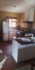 a kitchen with a refrigerator and a counter top at Nukakamma Guest House in Colchester