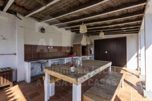 a dining room with a table in a villa at Casa da Praia by AcasaDasCasas in Santo Isidoro