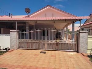 a house with a gate in front of it at Citadil Homestay in Miri