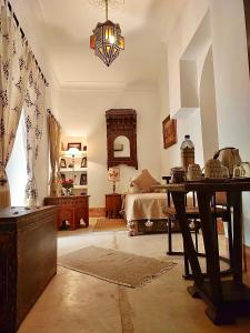 salon ze stołem i łóżkiem w obiekcie Riad Le Coq Berbère w Marakeszu