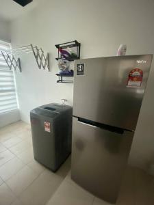 a refrigerator and a trash can in a room at Spacious+Minimal+Manjung City Centre in Seri Manjung