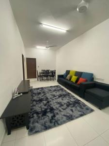 a living room with a couch and a rug at Spacious+Minimal+Manjung City Centre in Seri Manjung