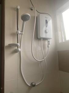 a shower in a bathroom with a shower head at Spacious+Minimal+Manjung City Centre in Seri Manjung