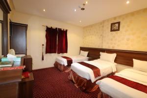a hotel room with two beds and a window at Ayan ALMUEABADH -1700m to ALharam in Mecca