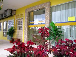 a building with red flowers in front of it at Sun Inns Hotel Equine, Seri Kembangan in Seri Kembangan