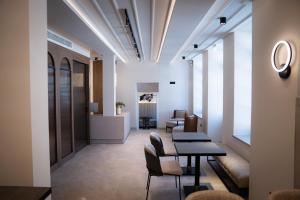 an office lobby with a table and chairs at Navria by Aetoma in Nafplio