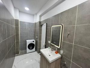 La salle de bains est pourvue d'un lavabo et d'un miroir. dans l'établissement Twins Apartment, à Përmet