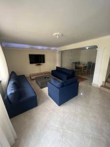 sala de estar con 2 sofás azules y TV en San Marcos Envigado Medellin en Envigado