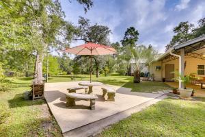 a picnic table and an umbrella in a park at Riverfront Florida Escape with Grill and Fire Pit! in Tallahassee