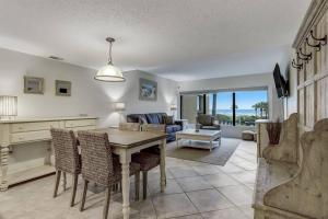 a kitchen and living room with a table and chairs at Unobstructed Oceanfront Views in Gated Community-2 Pools-Surf & Racquet B123 in Fernandina Beach