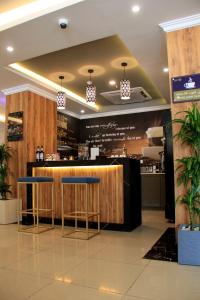 a bar in a restaurant with two stools at شقق سوات للشقق المخدومة 4 in Al Khobar